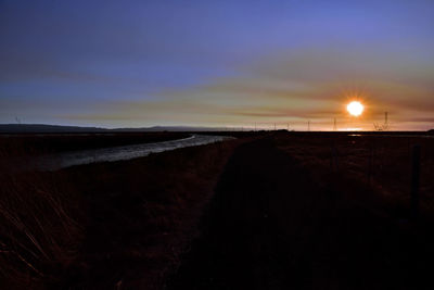 Scenic view of beach against sky during sunset