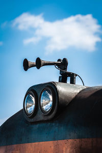 Low angle view of camera against blue sky