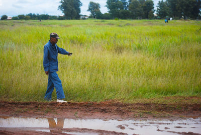 Full length of man standing on field