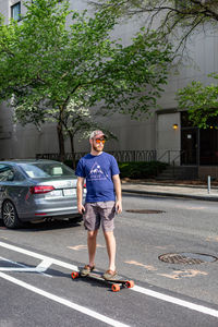 Full length portrait of man standing on road