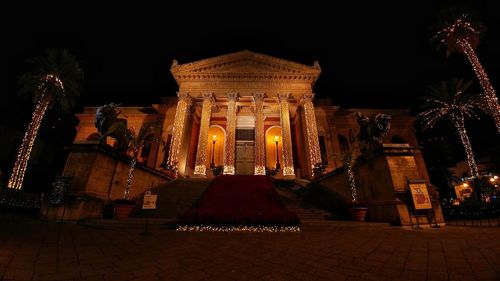 Illuminated buildings in city at night