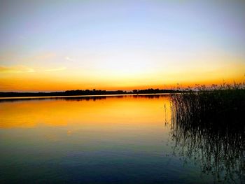 Scenic view of lake against romantic sky at sunset