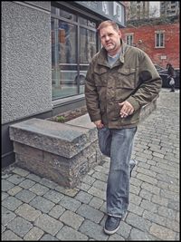 Portrait of man standing on street