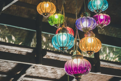 Low angle view of illuminated lanterns hanging on ceiling