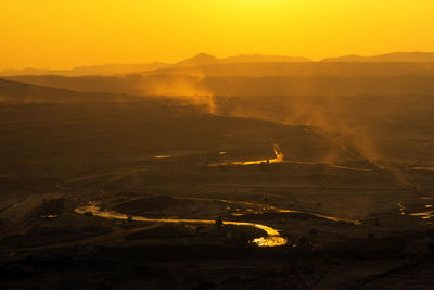 Aerial view of landscape against sky during sunset