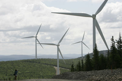 Windmill on field against sky