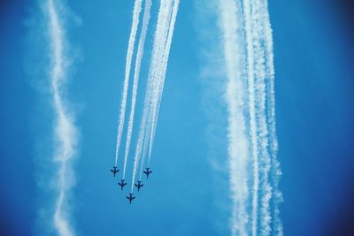 Low angle view of airplane flying in sky