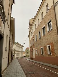 Empty alley amidst buildings in city