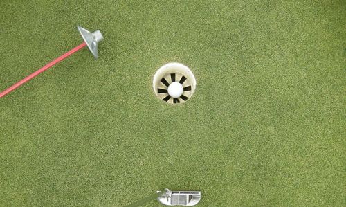 High angle view of golf club by hole at course