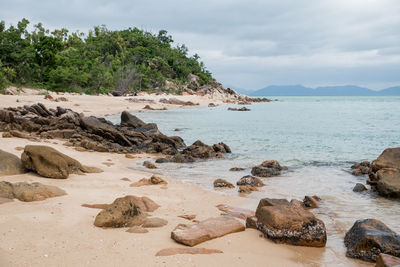 Rocks on beach against sky