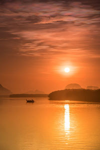 Scenic view of sea against orange sky