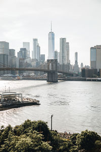 Scenic view of river by buildings against sky