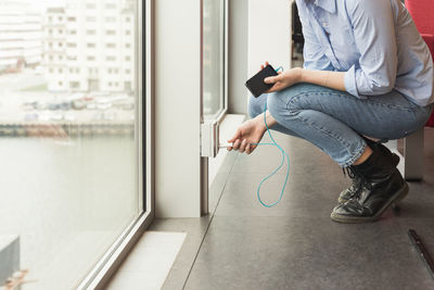 Woman plugging phone charger