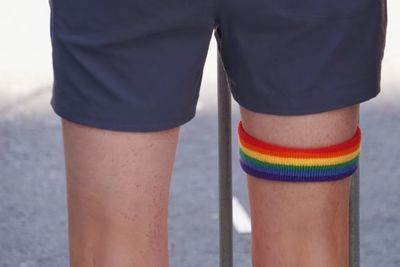 Midsection of man wearing colorful band