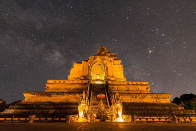 Low angle view of illuminated building against sky at night