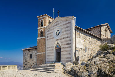 Low angle view of building against clear blue sky