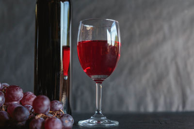 Close-up of red wine in glass on table