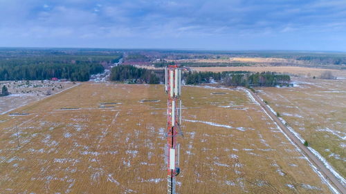 High angle view of street amidst field against sky