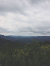 Scenic view of mountains against cloudy sky