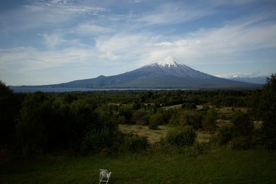 Scenic view of field and mountains against sky