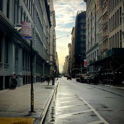 City street amidst buildings against sky