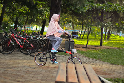Side view of woman riding bicycle