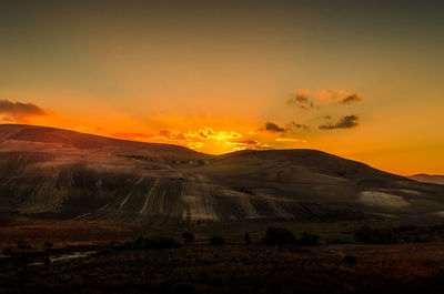 Scenic view of field against sky during sunset