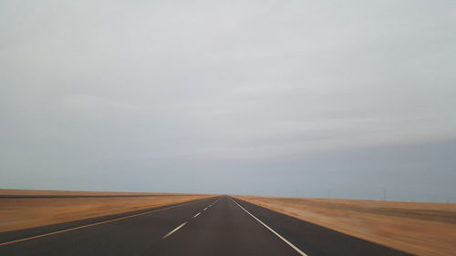 Empty road against sky