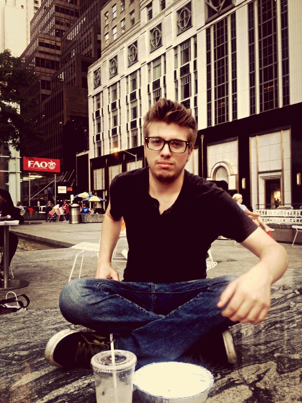 young adult, lifestyles, person, looking at camera, leisure activity, portrait, casual clothing, front view, young women, building exterior, sitting, sunglasses, architecture, holding, built structure, standing, waist up