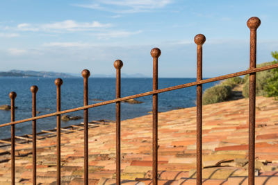 Mediterranean landscape with rusted metal fence in saint tropez in southfrance with ceramic tiles