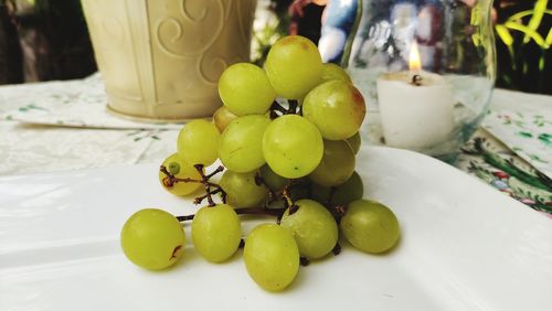 Close-up of grapes in plate on table