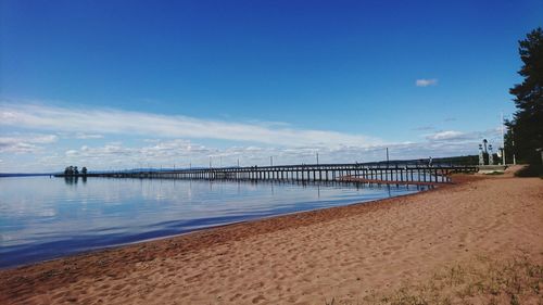 Scenic view of beach against blue sky