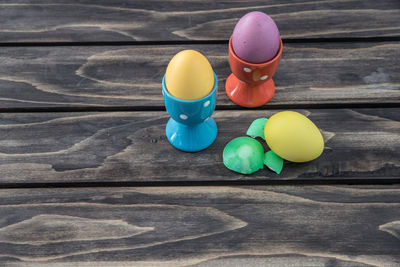 High angle view of easter eggs with cups on table
