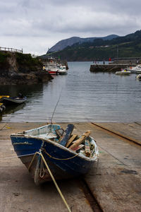 Boats moored on river against sky