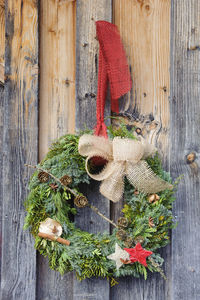 Christmas decoration hanging on wooden fence