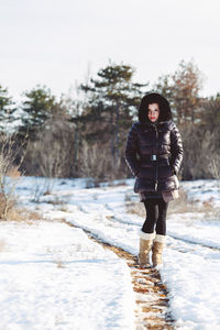 Portrait of teenage girl standing in snow