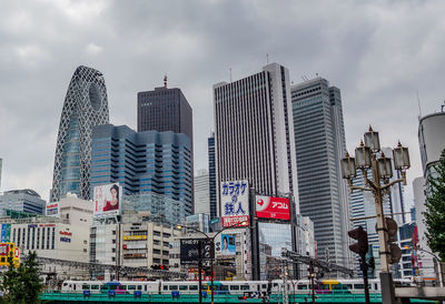 Modern buildings against sky in city