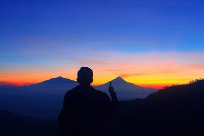 Scenic view of landscape against sky at sunset