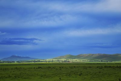 Scenic view of mountains against cloudy sky