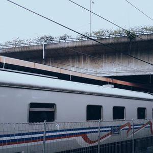 Train on bridge against sky