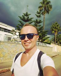 Portrait of young man wearing sunglasses standing outdoors