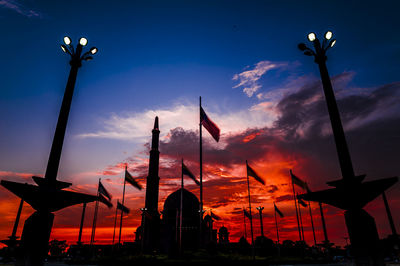 Silhouette of mosque against atmospheric sky