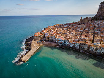 High angle view of sea and buildings against sky