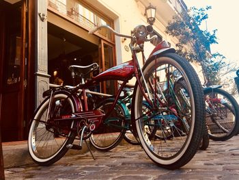 Bicycles parked on footpath against building