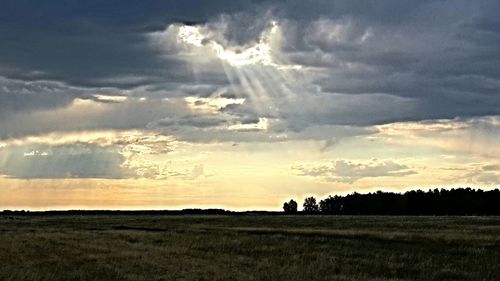 Scenic view of landscape against cloudy sky