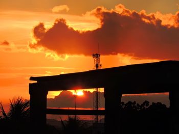 Silhouette tower against sky during sunset