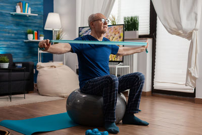 Senior man working out at home