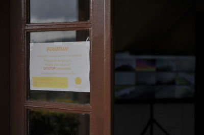 Close-up of text on glass window