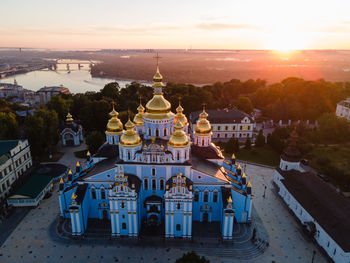 High angle view of buildings in city at sunset