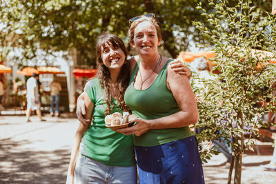 Portrait of a smiling young woman standing outdoors